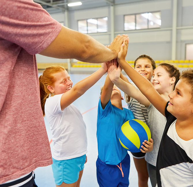 coach giving high five to students